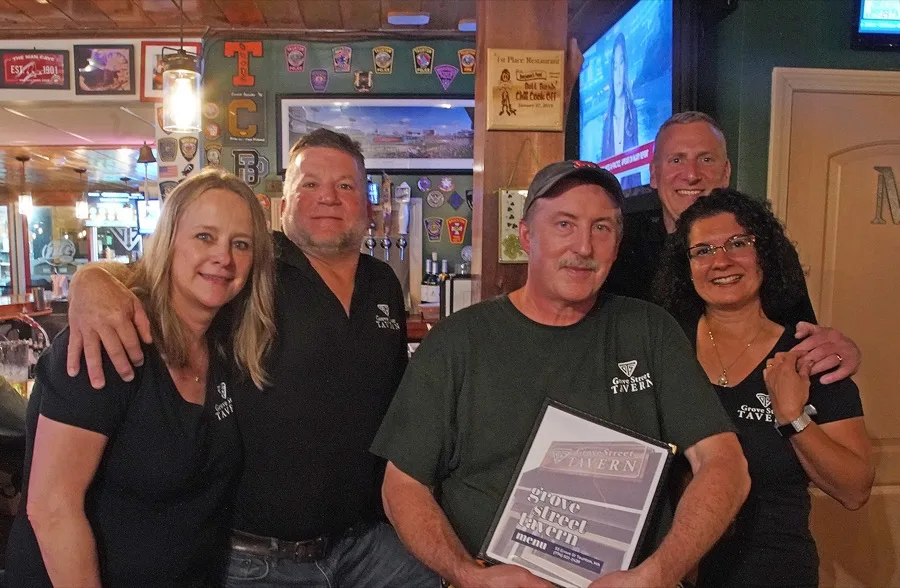 Owners and staff of Grove Street Tavern behind the bar