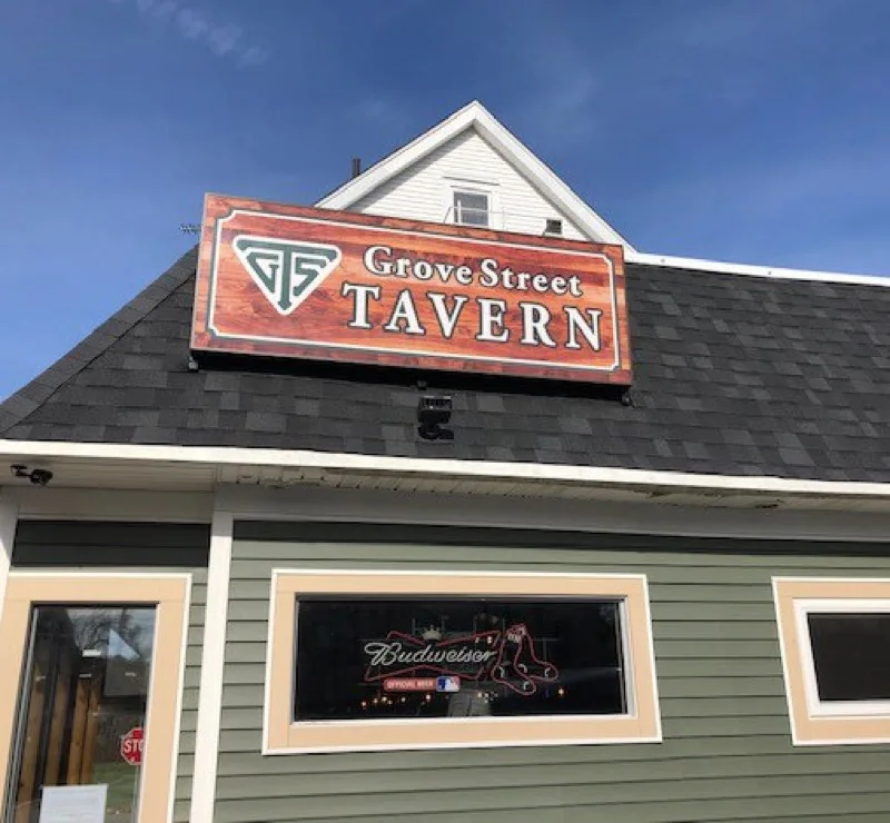 Exterior of Grove Street Tavern with rooftop sign